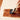 person applying wood varnish or polish to a board